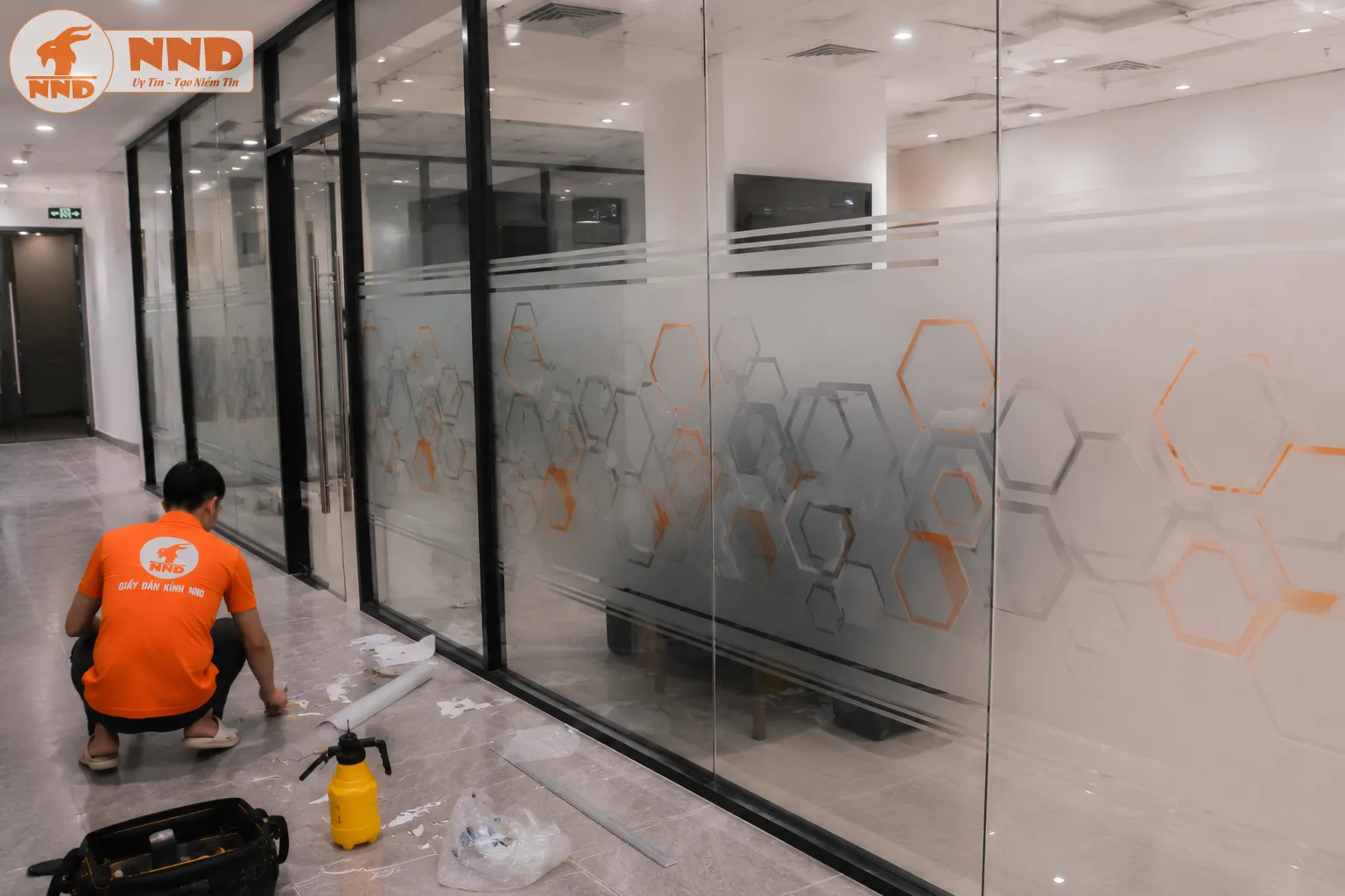 Decal mờ in họa tiết lục giác phối màu xám – cam mang phong cách công nghệ. Phù hợp văn phòng hiện đại, vừa phân chia không gian làm việc vừa tạo hiệu ứng trang trí chuyên nghiệp.