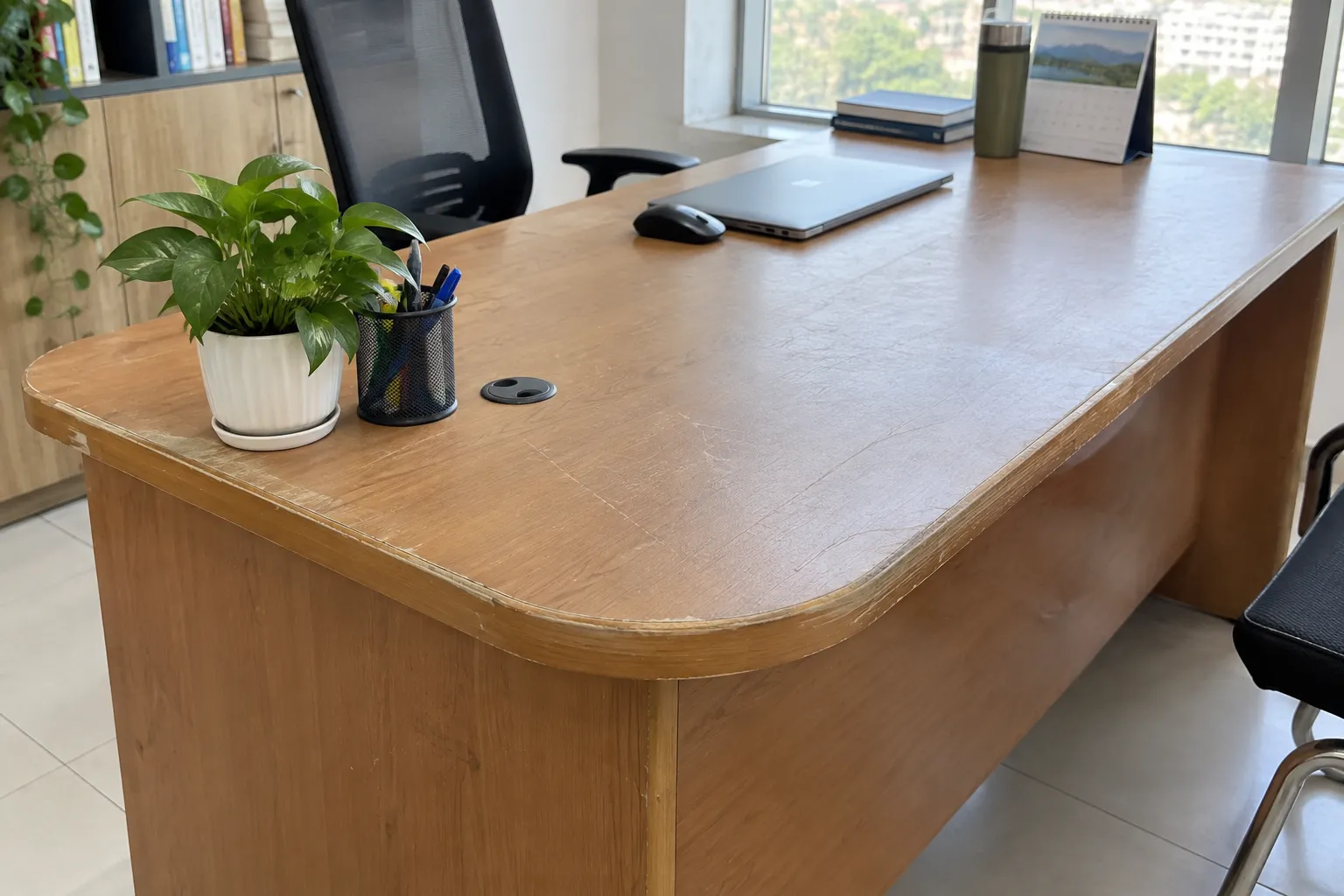 Bàn làm việc cũ có mặt bàn trầy xước và cạnh bo cong trước khi dán decal vân gỗ