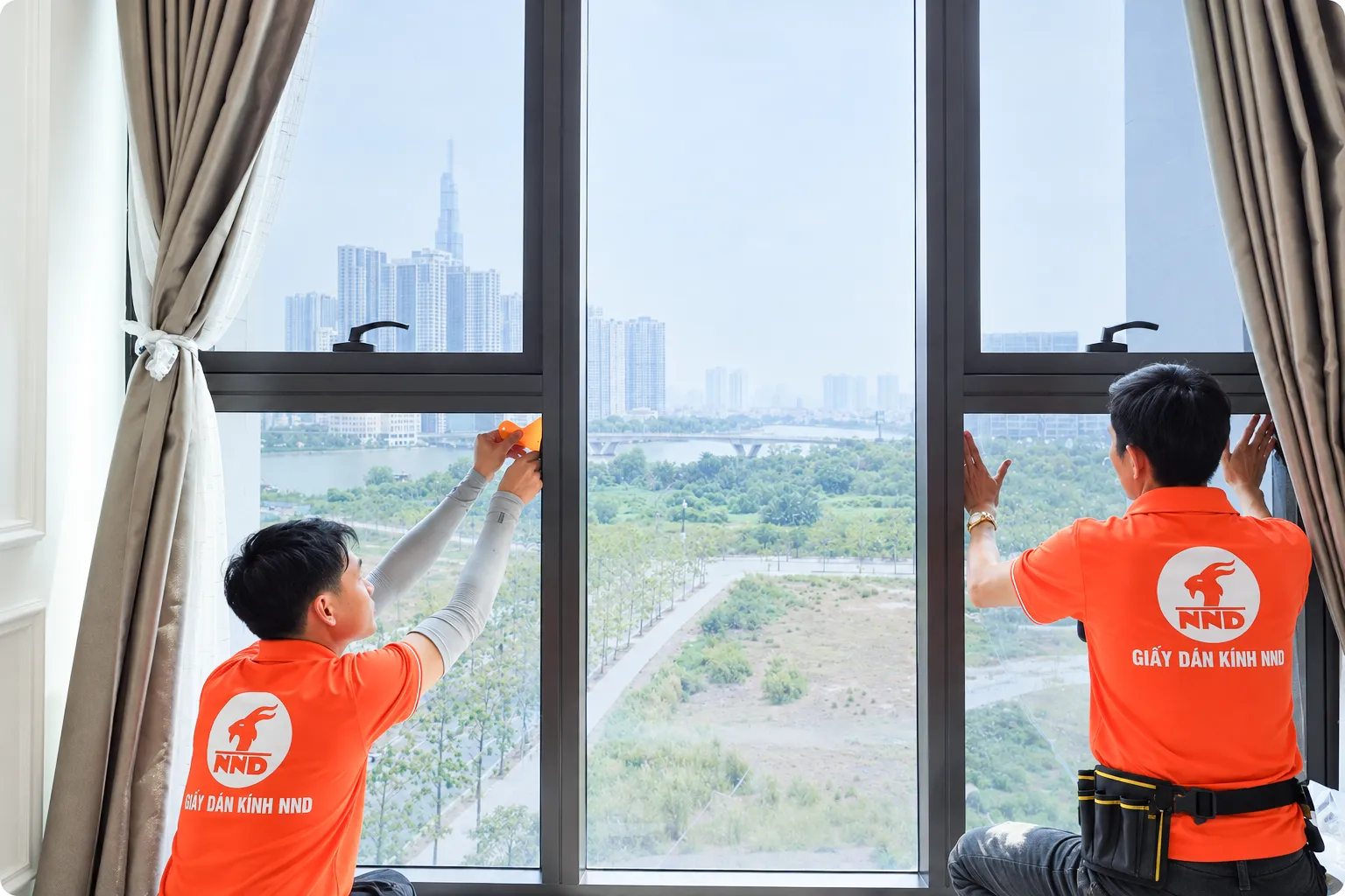 Hai kỹ thuật viên NND hoàn thiện phim cách nhiệt trên các ô kính tại biệt thự Vinhomes Ocean Park Gia Lâm